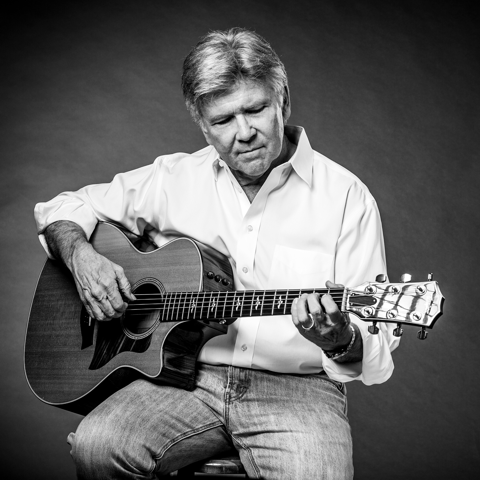 Musician portrait playing guitar, black and white